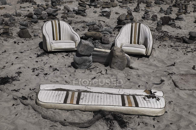 Shabby retro armchairs with sofa on arid rocky ground — Stock Photo