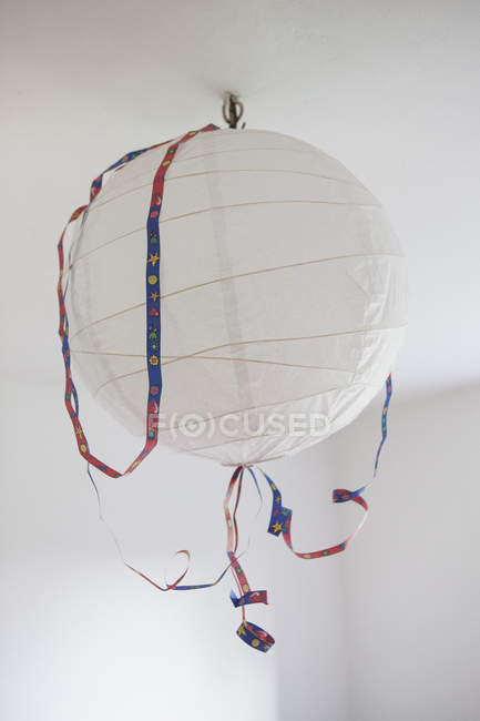 Close up view of paper lantern hanging from ceiling — Stock Photo