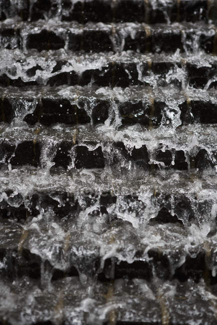 Close up view of water flow flowing through steps — Stock Photo