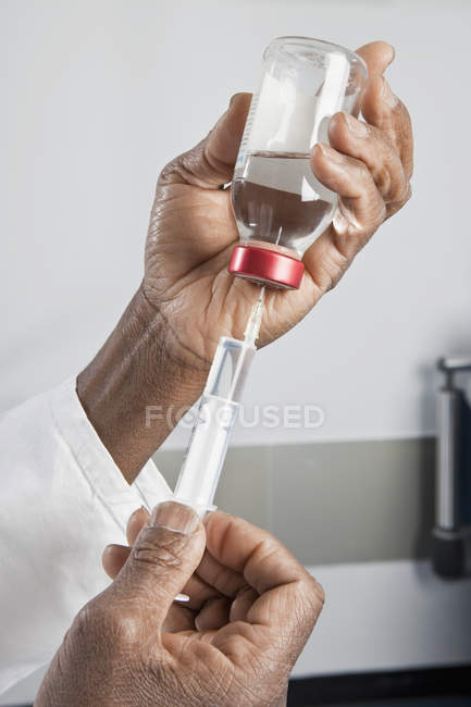 Coltiva la siringa di riempimento delle mani del medico dal flacone — Foto stock