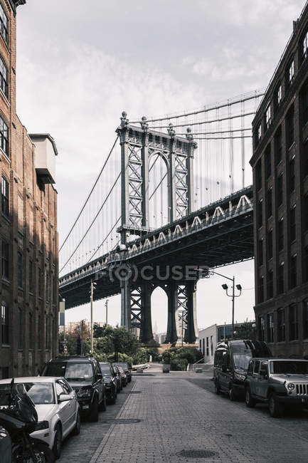 Scena di strada con file di auto parcheggiate e Manhattan Bridge sullo sfondo — Foto stock