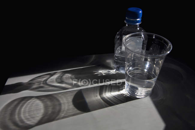 Plastic Bottle And Cup Of Water On Table Simplicity Refreshment Stock Photo