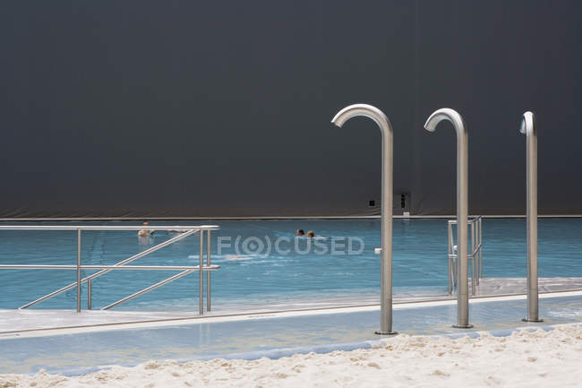 Showers next to indoor swimming pool at tropical theme park — Stock Photo