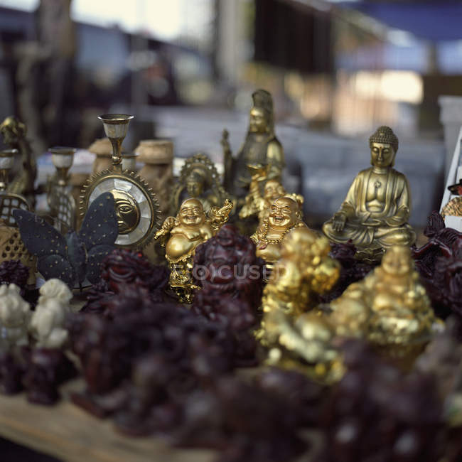 Various Buddha statues for sale at flea market — Stock Photo