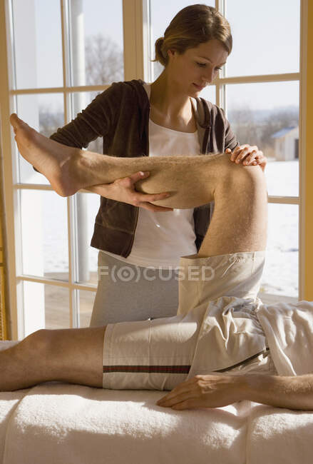 Jeune femme massage homme massage — Photo de stock