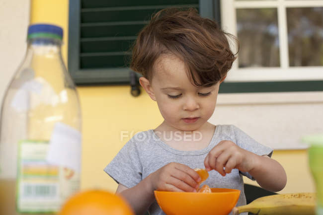 Little Boy Preparing Slices Of Fresh Orange For Breakfast Brown