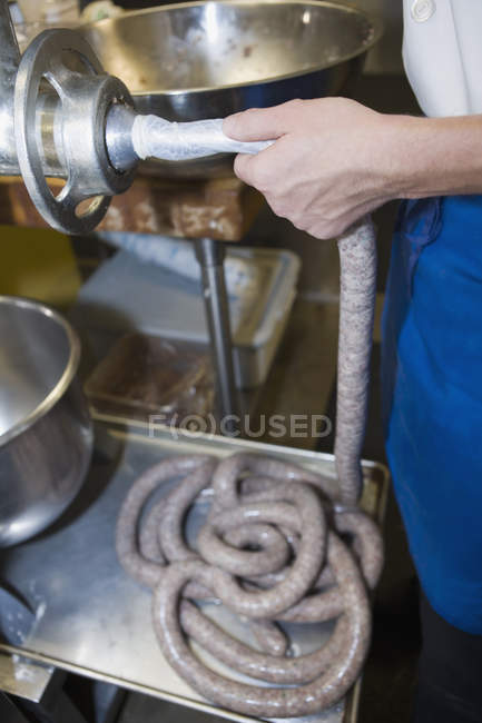 Crop hands making fresh sausages in  kitchen — Stock Photo
