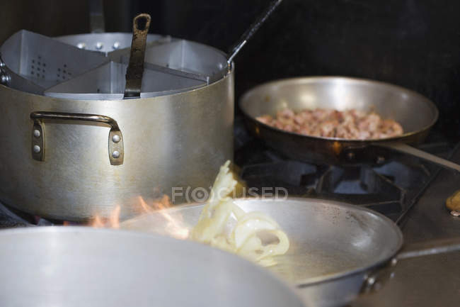 Pots and pans of food cooking on stove — Stock Photo