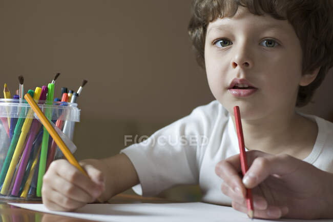 A young boy drawing with a friend, viewpoint of boy — Stock Photo