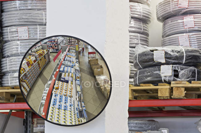 Parabolic mirror reflecting shelves in warehouse store — Stock Photo