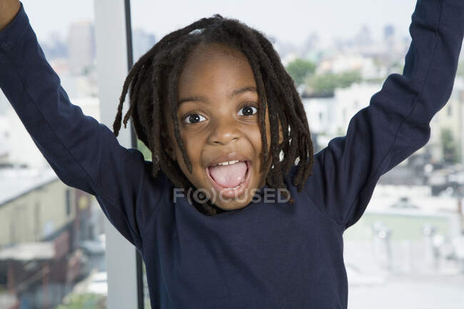 A young boy with his arms raised in excitement — Stock Photo