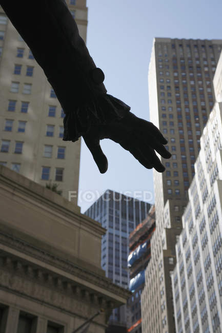 Silhouetted hand against skyscrapers facades — Stock Photo