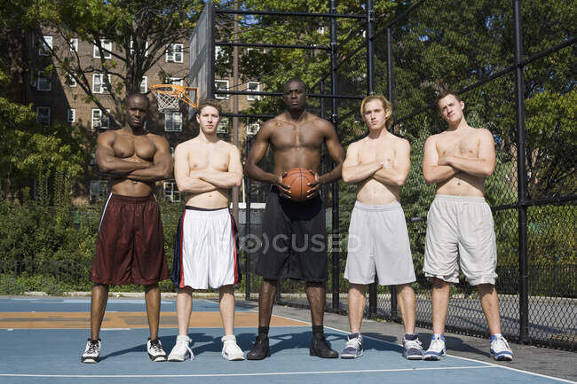 Five basketball players, in a row — Stock Photo