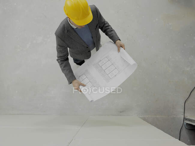An architect reviewing work on a construction site — Stock Photo