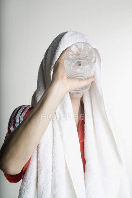 A man drinking from water bottle after exercising — Stock Photo