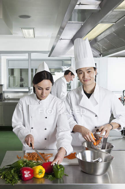 Two chefs doing prep work in a commercial kitchen — Stock Photo