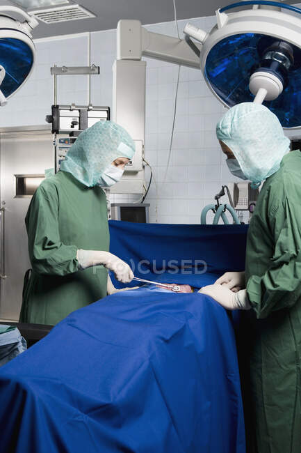 Two surgeons operating on a patient — Stock Photo