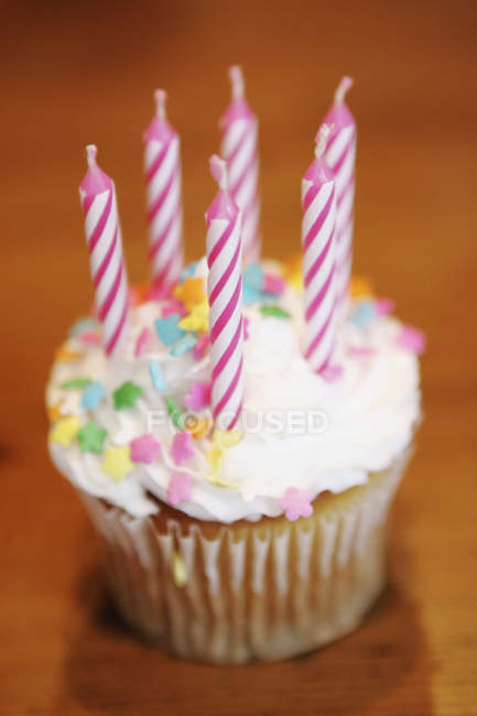 Close up view of cupcake with six pink candles on table — Stock Photo