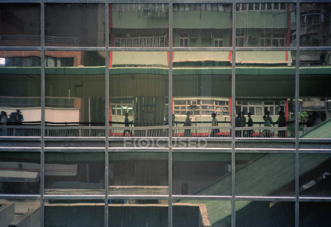 Building with reflections of city life on facade, Hong Kong, China — Stock Photo