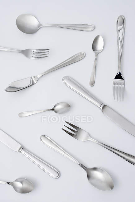 Different cuttlery and kitchen utensils on grey surface — Stock Photo