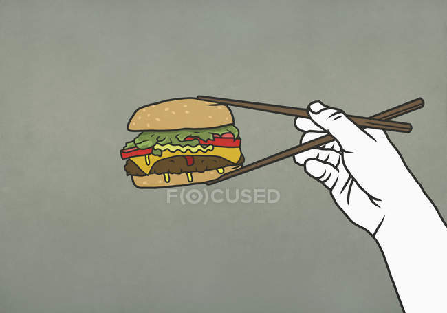 Uomo che mangia cheeseburger con bacchette — Foto stock