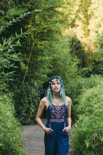 Ritratto di donna con capelli blu su sentiero in un parco lussureggiante — Foto stock
