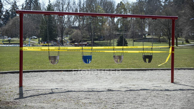Swing set taped off in playground during COVID-19 pandemic — Stock Photo