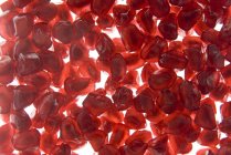 Red seeds back light fruit — Stock Photo