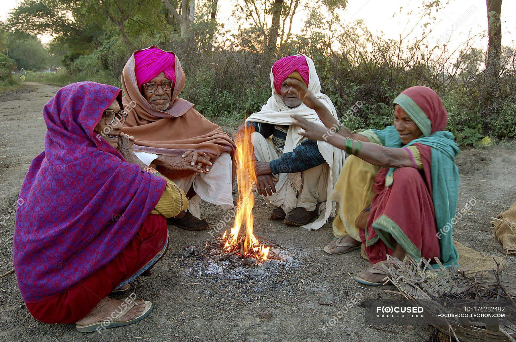 Indian villagers in national clothes sitting beside bonfire. Salunkwadi