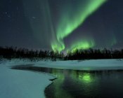 Reflected aurora over frozen Laksa lake — Stock Photo