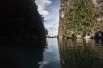 Schooner near rugged limestone islands — Stock Photo