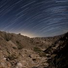 Star trails over rugged canyon — Stock Photo