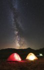 Glowing tents under Milky Way — Stock Photo