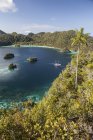 Limestone islands around lagoon with boat — Stock Photo