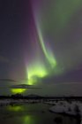 Aurora borealis over creek by Fish lake — Stock Photo