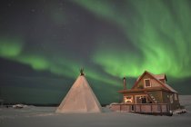 Aurora borealis above village — Stock Photo
