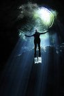 Cavern diver ascending to light — Stock Photo