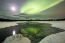 Aurora borealis and full Moon — Stock Photo
