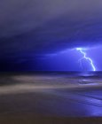 Bolt of lightning from approaching storm at beach in Miramar, Argentina — Stock Photo
