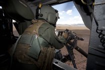 New Mexico, Kirtland Air Force Base - August 25, 2012: HH-60G Pave Hawk gunner of 512th Rescue Squadron shooting GAU-17/A — Stock Photo