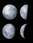 Four phases of moon on black background — Stock Photo
