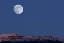 Pleine lune au-dessus des montagnes à Alpenglow, New Aiyansh, Colombie-Britannique, Canada — Photo de stock