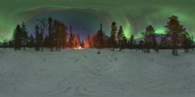 Panorama of aurora over winter forest with glowing tent in Kola Peninsula, Russia — Stock Photo