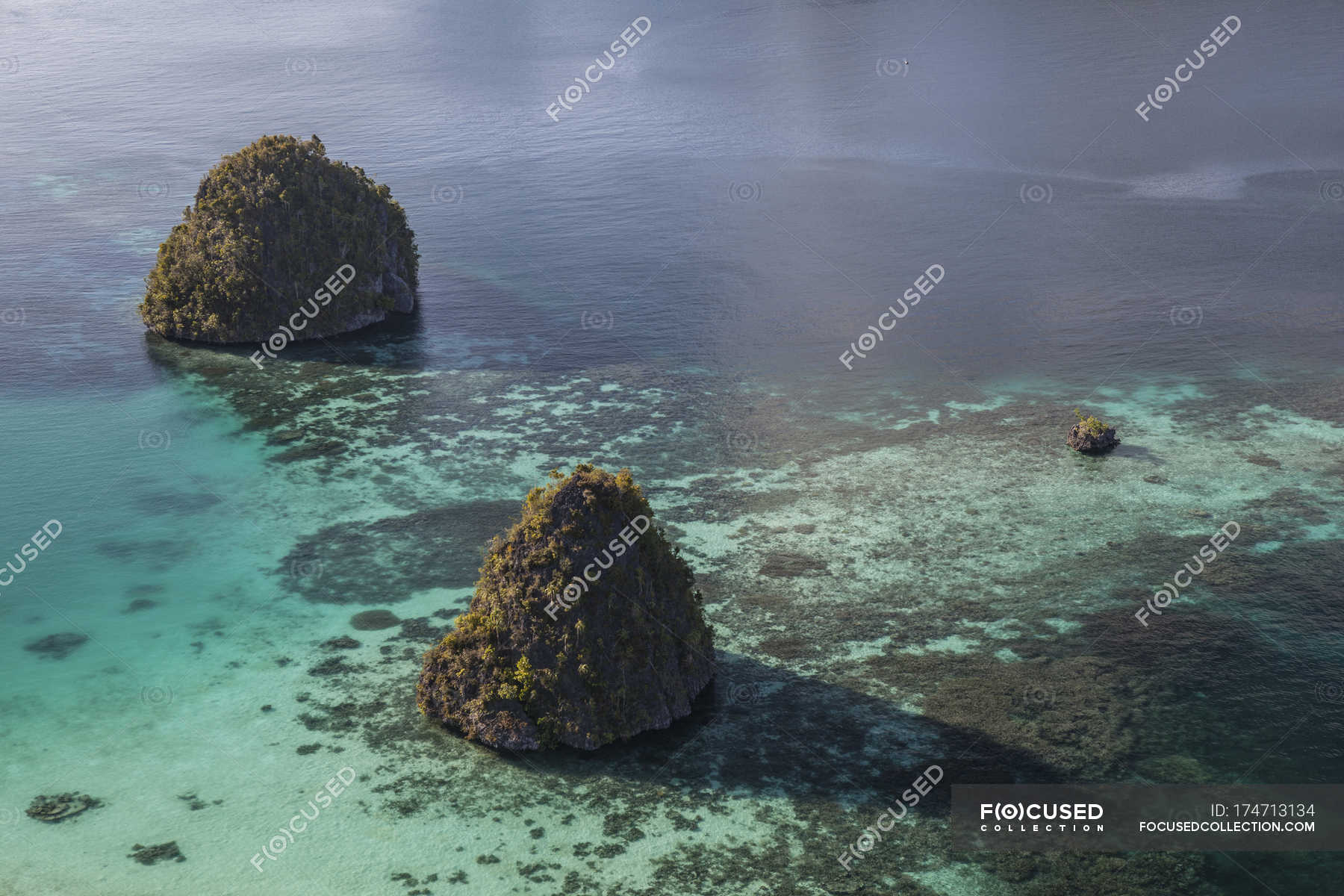 Limestone islands surrounded by coral reef — batanta, translucent ...