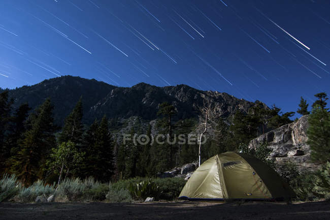 Star trails and lone tent — Stock Photo