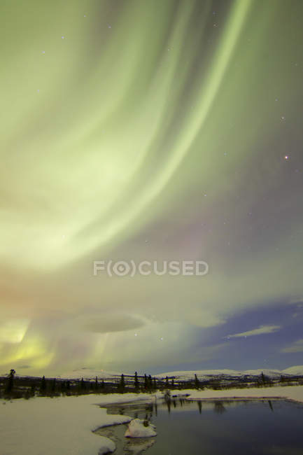 Aurora borealis over creek by Fish lake — Stock Photo