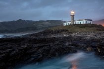Lighthouse just after sunset with the light on — Stock Photo