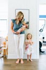 Portrait of mother with her daughter and newborn son at home — Stock Photo