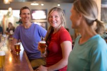 Three female friends enjoy a beer at a brewery in Government Camp, OR. — Stock Photo