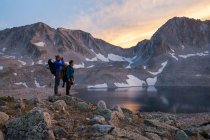 Man and woman tourists descend the Northeast Ridge of Capitol Peak, Elk Mountains, Colorado. — Stock Photo